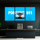 Porsche 911 Gulf poster set by Dripster showing a blue and orange race car split across three panels on a black wall
